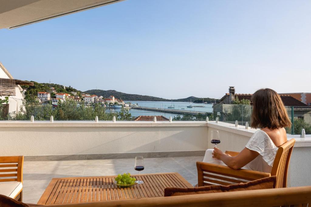 Private terrace with a glass of wine and the bay